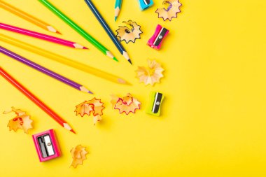 Renkli arka planda kalem açacağı. Kalem ve kalem talaşı. Kırtasiye malzemeleri. Okul malzemeleri. Okul ürünleri. Düz yatıyordu. Mesaj için yer. Boşluğu kopyala.