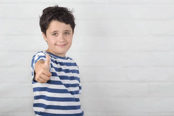 Malý chlapec s úsměvem na palec — Stock fotografie
