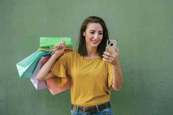 Joven Mujer Feliz Sosteniendo Una Bolsa Compras Teléfono Inteligente Sobre — Foto de Stock