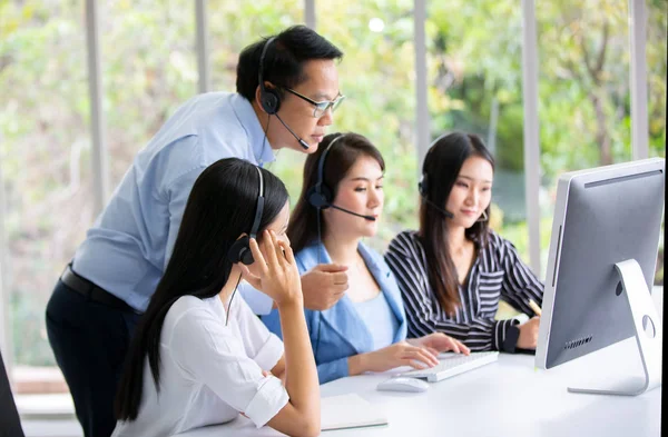 operator customer service in the office, Technical support operator with headset working at laptop and computer, Business people talking on telephone with headset at office for customer help service concept