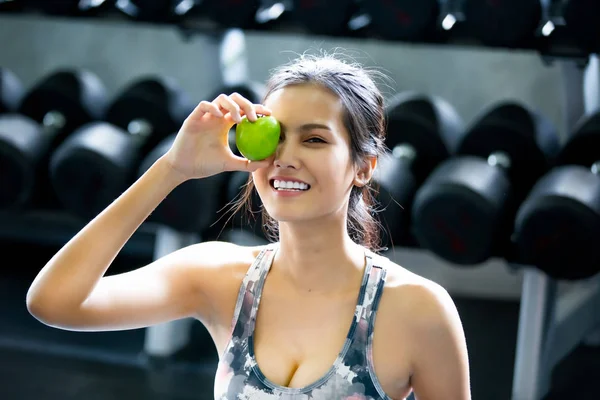 Portrait Of  Young Woman Exercising At Gym