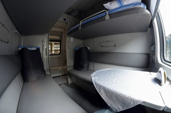 Compartment and berth with bed-linen packages in Ukrainian Railways First Class sleeping carriage of a passenger train