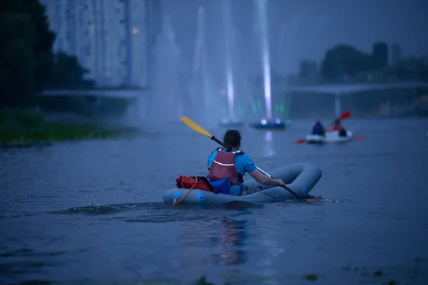 Yağmurda kayık süren adam düşüyor, akşam ışığı...