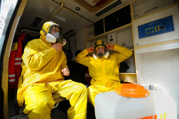 Paramedics Sitting Ambulance Car Putting Yellow Protective Costumes Masks Preparing — Stock Photo, Image