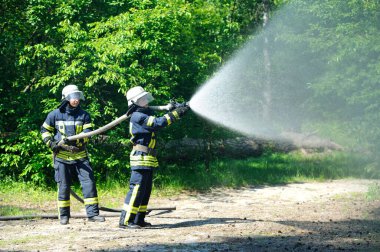 İtfaiye ekibi eğitimi: ormandaki yangınla mücadele eden koruyucu giysili itfaiyeciler. 5 Haziran 2019. Sviatoshyn İlçesi Ormanı, Kievskaya oblast, Ukrayna