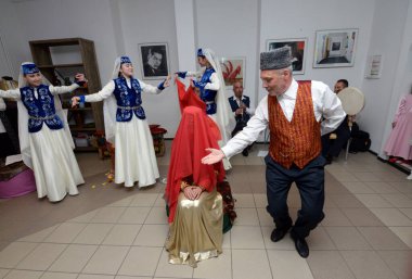 Kırım Tatar geleneksel nikahı: bir damat toplantı sırasında gelinle dans ediyor. Kırım Tatar Kültürü Günleri. 27 Şubat 2019. Kiev, Ukrayna