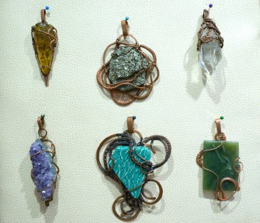 Handimade jewelry made of semi precious natural stones - jaspers, agates, nephritis in copper frames clipart