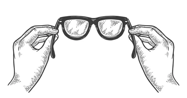 Gafas en las manos esbozar ilustración vectorial grabado vintage. Scratch board estilo imitación. Imagen dibujada a mano en blanco y negro . — Vector de stock