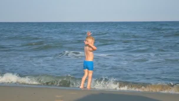Щасливий Маленький Хлопчик Біжить Уздовж Узбережжя Моря Тропічному Пляжі — стокове відео