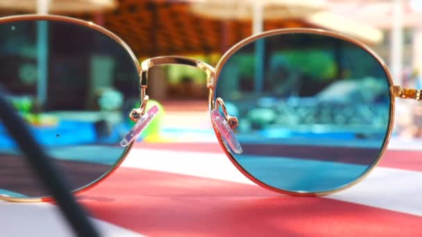 Sonnenbrille. Poolreflexion. Konzept des Urlaubs auf See. Kinder beobachten, spielen. Zeitraffer. — Stockvideo