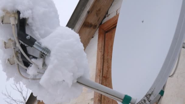 Ένας πύργος πιάτο στην ταράτσα καλυμμένο με χιόνι. Πολύ χιόνι στο δορυφορικό πιάτο. — Αρχείο Βίντεο