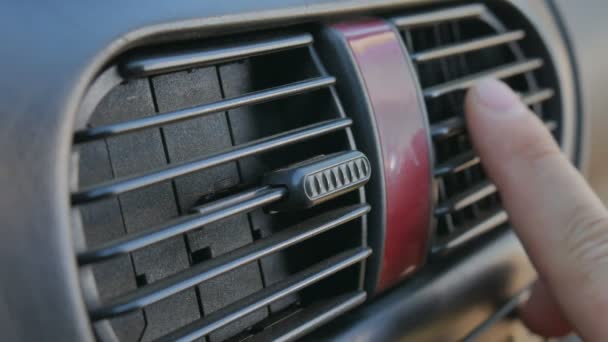 Close-up of hand adjusting air vents to change wind direction inside the car. Too cool or too warm air condition. — Stock Video