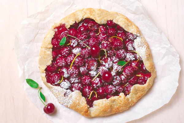 Homemade Cherry Pie, Freshly Baked Cherry Galette Decorated with Icing Sugar and Lemon Zest