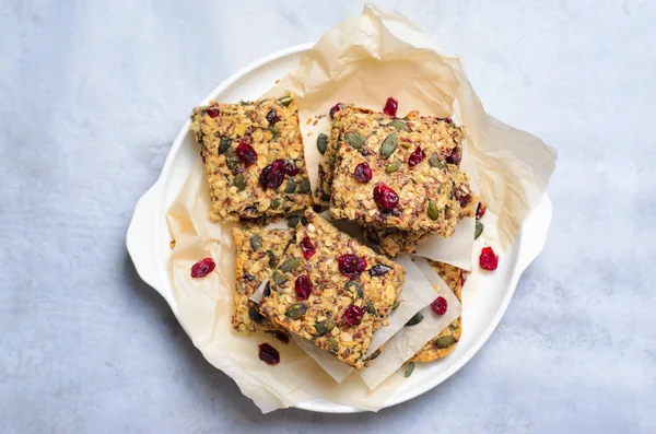 Granola Bars, Healthy Homemade Snack, Superfood Bars with Cranberry, Pumpkin Seeds, Oats, Chia and Flax Seed on bright background, Vegan Meal