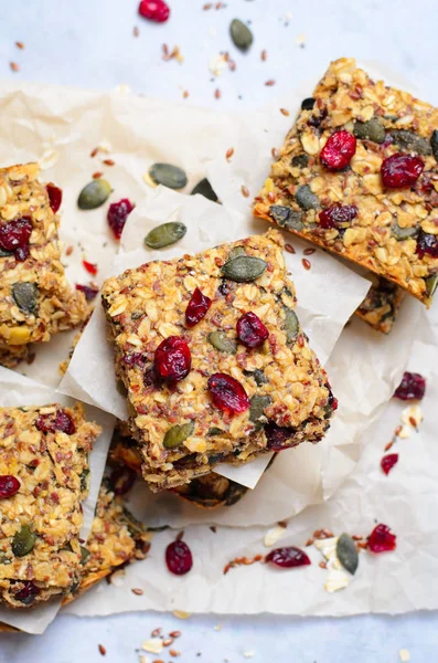 Granola Bars, Healthy Homemade Snack, Superfood Bars with Cranberry, Pumpkin Seeds, Oats, Chia and Flax Seed on bright background, Vegan Meal