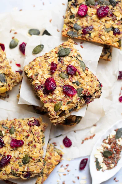 Granola Bars, Healthy Homemade Snack, Superfood Bars with Cranberry, Pumpkin Seeds, Oats, Chia and Flax Seed on bright background, Vegan Meal