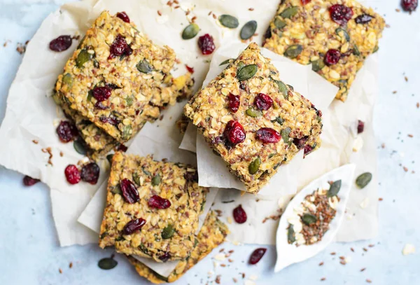 Granola Bars, Healthy Homemade Snack, Superfood Bars with Cranberry, Pumpkin Seeds, Oats, Chia and Flax Seed on bright background, Vegan Meal