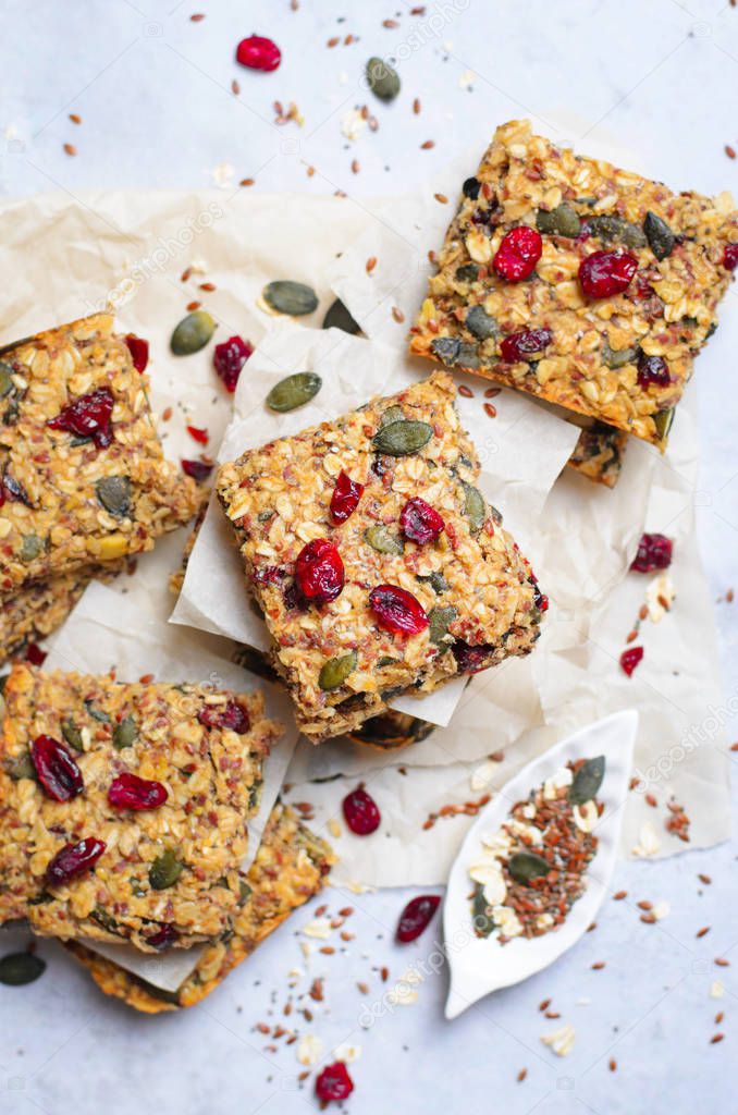 Granola Bars, Healthy Homemade Snack, Superfood Bars with Cranberry, Pumpkin Seeds, Oats, Chia and Flax Seed on bright background, Vegan Meal