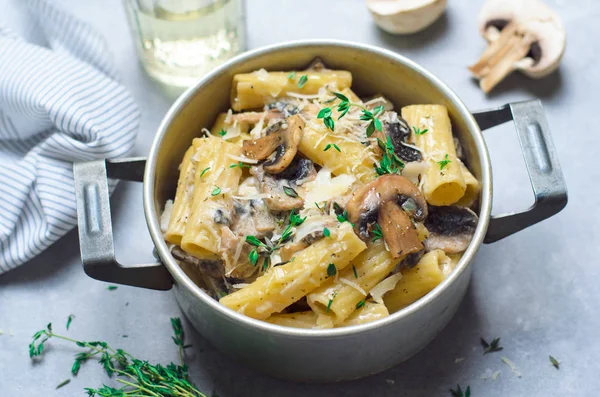 Creamy Mushroom Pasta with Fresh Thyme and Parmesan in a Vintage Pot, Italian Cuisine