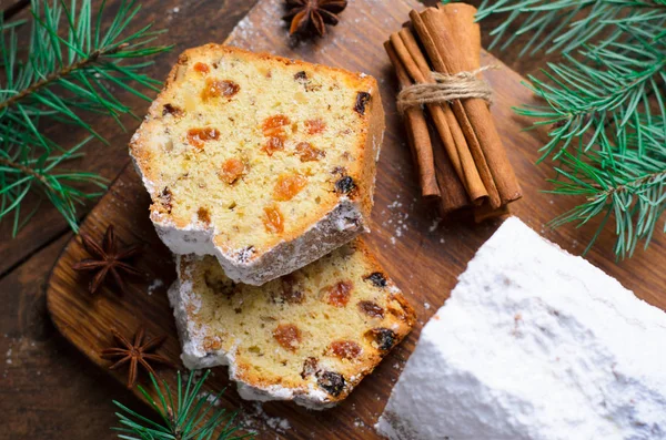 Fruit Loaf Cake Dusted with Icing Sugar, Christmas and Winter Holidays Treat, Homemade Cake with Raisins on Wooden Background