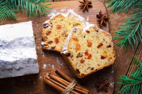 Fruit Loaf Cake Dusted with Icing Sugar, Christmas and Winter Holidays Treat, Homemade Cake with Raisins on Wooden Background