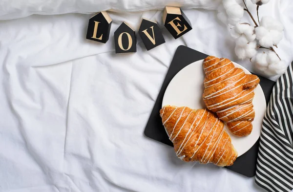 Romantic Breakfast in Bed, Croissants, Love Letters on White Bed Sheet, Top View