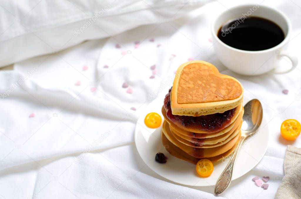 Romantic Breakfast in Bed, Pancakes and Coffee on White Bed Sheet, Top View