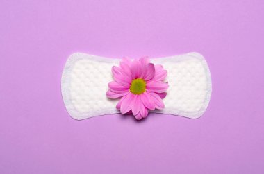 Kadının hijyenik ped ve Gerbera papatya çiçek pembe arka plan, kadın hijyen kavramı üzerinde