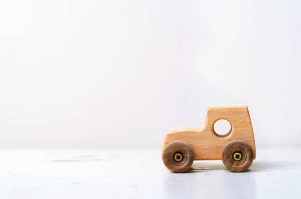 Wooden Car Handmade Toy on White Background, Copy Space