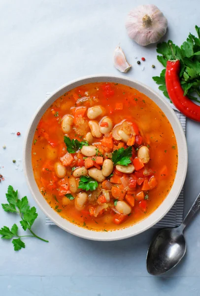 Vegetable Soup with White Beans, Homemade Soup on Bright Background, Vegetarian Food, Top View