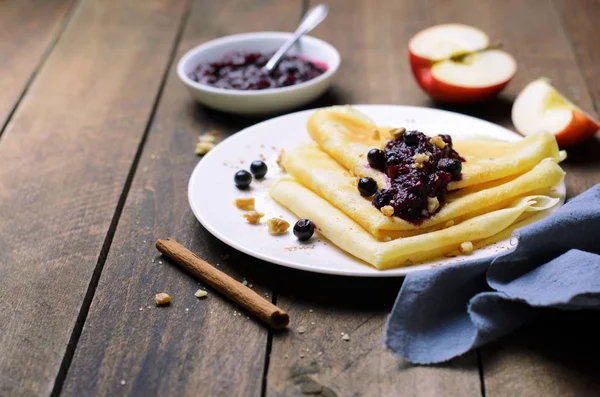 Crepes with Black Currant Jam on Dark Wooden Background, Homemade Dessert
