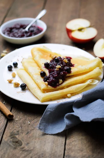 Crepes with Black Currant Jam on Dark Wooden Background, Homemade Dessert