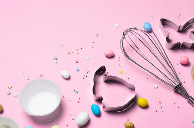 Paskalya kavramı, çerez kesici, yumurta, şeker şeker ve çikolata yumurta parlak arka planda, üstten görünüm