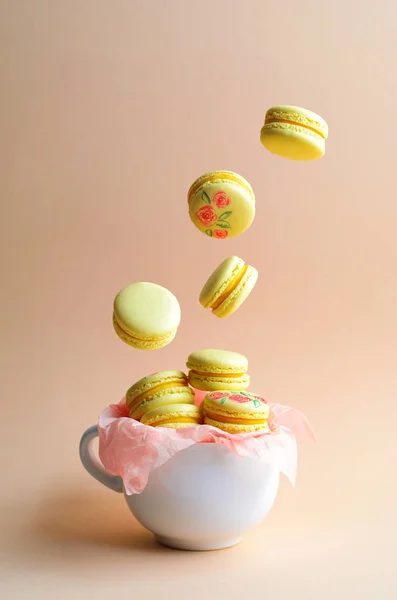 Levitating Colorful Macarons, French Dessert on Bright Background