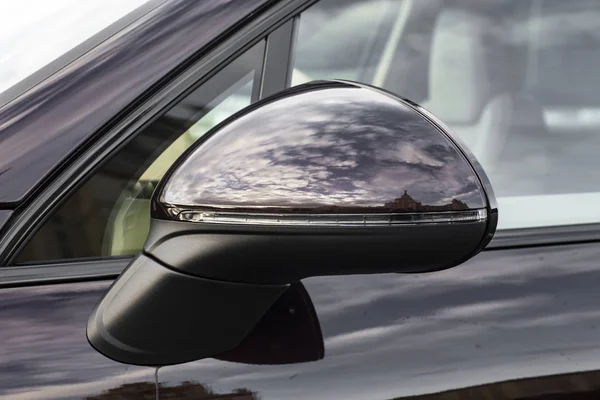 Luxury car rear view mirror. Exterior detail.