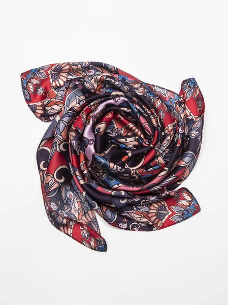 Multicolor silk scarf on white background. Top view.