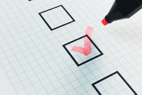 The red pen check point in black box on paper.