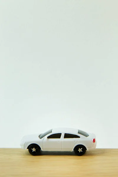 The white car toy on wood table  image close up.