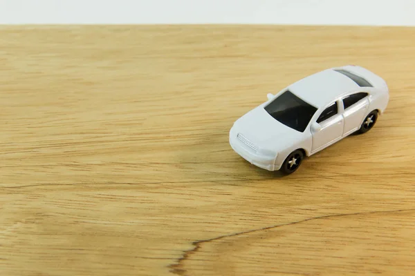 The white car toy on wood table  image close up.