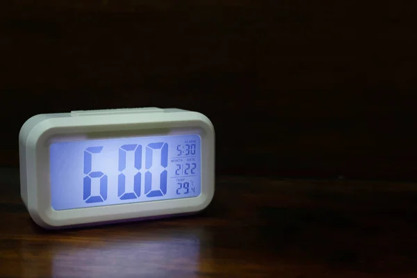 The digital alarm clock  6:00 close up image.