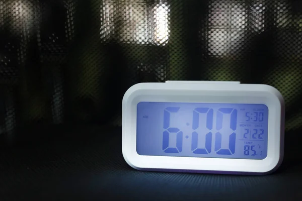 The digital alarm clock  6:00 close up image.