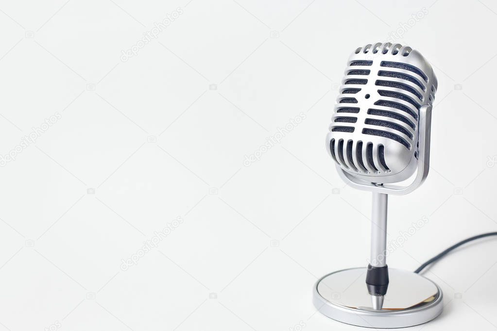 The vintage microphone close up image on white background