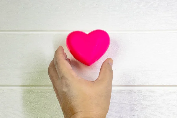 pink Heart and hand for medical content.