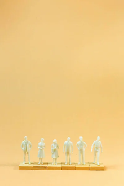 Witte figuur miniatuur op oranje pastel voor zakelijke inhoud. — Stockfoto