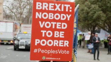 LONDON, circa 2019 - Close-up shot of Pro-EU Remain supporters holding posters and waving at drivers in Westminster Parliament, London, England, UK