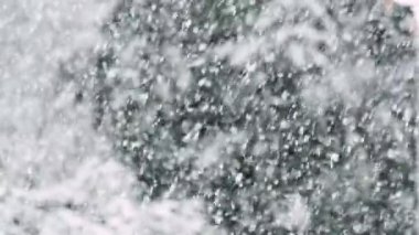 Heavy snowfall heralds the start of the winter season in the suburbs of a major city, filmed in slow motion to reveal snowflakes in glorious detail