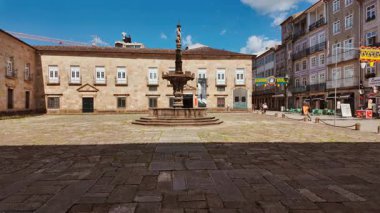 BRAGA, Portugal, 17 June 2025 - Largo do Paco Square features arcaded palace wings stone fountain and shaded seating inviting visitors in Braga, Portugal
