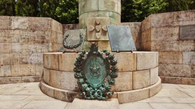 The statue of Afonso Henriques depicts the first Portuguese king with sword and shield standing resolutely before the castle walls in Guimaraes, Portugal