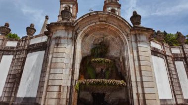 Sanctuary of Bom Jesus do Monte crowns the summit with white baroque church monumental stairway and panoramic views across Braga, Portugal
