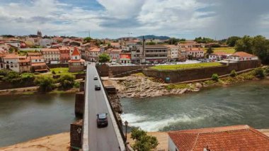 BARCELOS, Portugal, 19 June 2025 - The city of Barcelos unfolds in a broad establishing view that introduces the historic center with traditional houses church towers stone paving and public squares